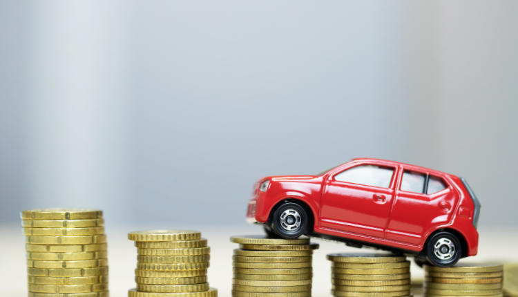 Image showing a comparison between an auto loan and a personal loan for buying a car, with a scale tipping towards the better option.