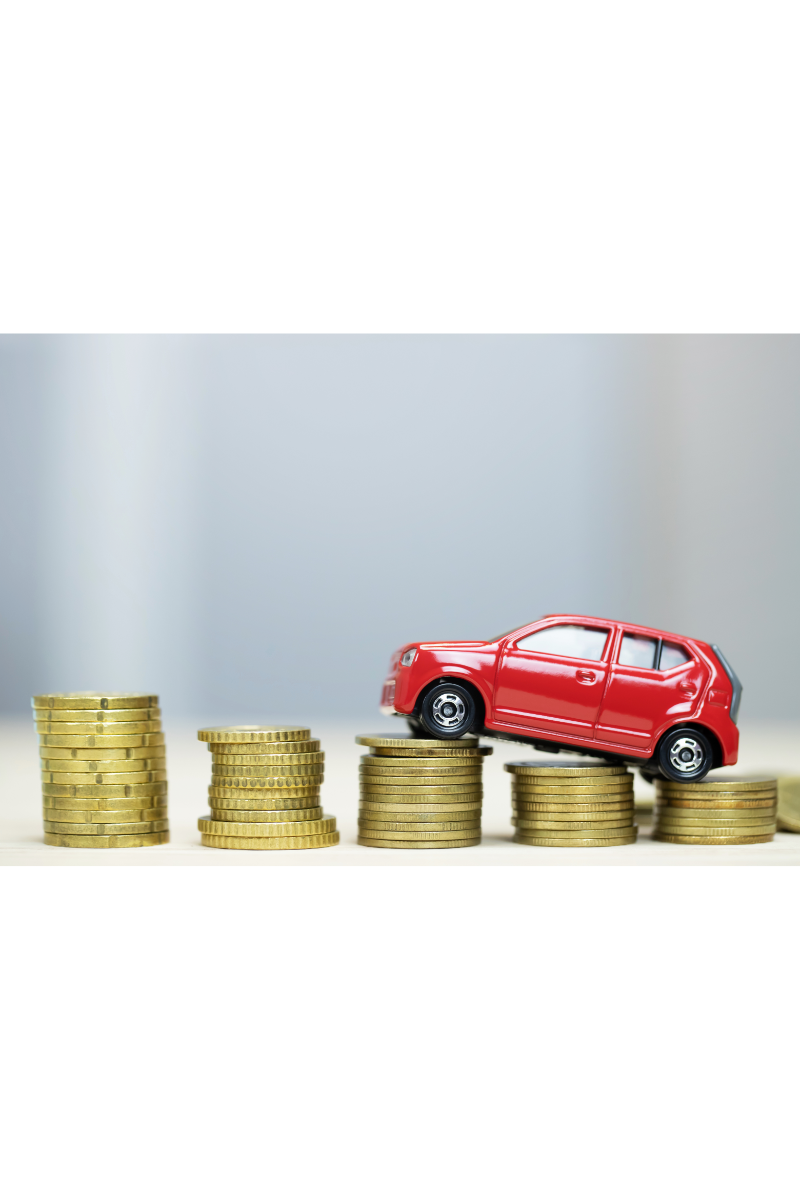 Image showing a comparison between an auto loan and a personal loan for buying a car, with a scale tipping towards the better option.