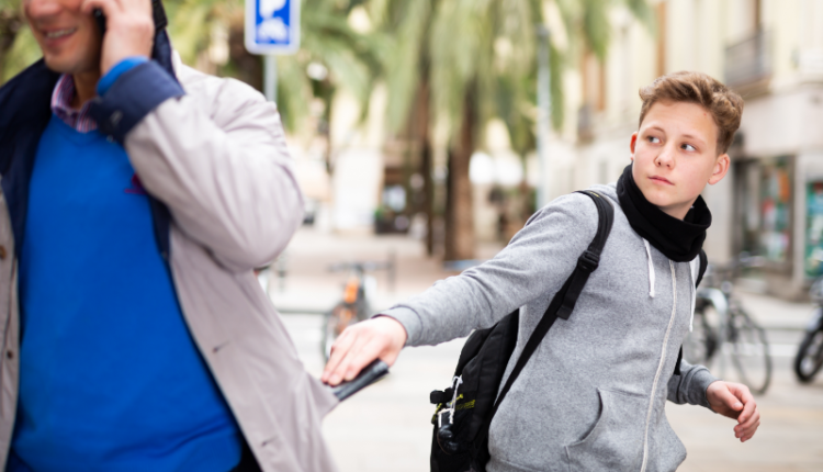 Illustration showing a hand holding a smartphone with a lock symbol and eraser icon, representing remote data protection and recovery for stolen phones