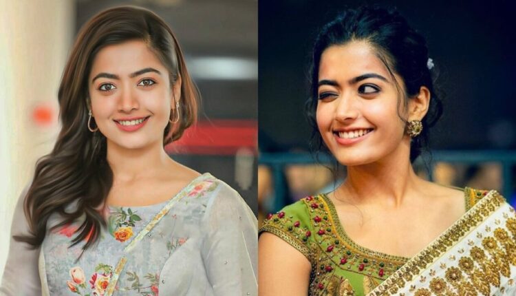 Rashmika Mandanna smiling at a film premiere, showcasing her elegant style and vibrant personality.
