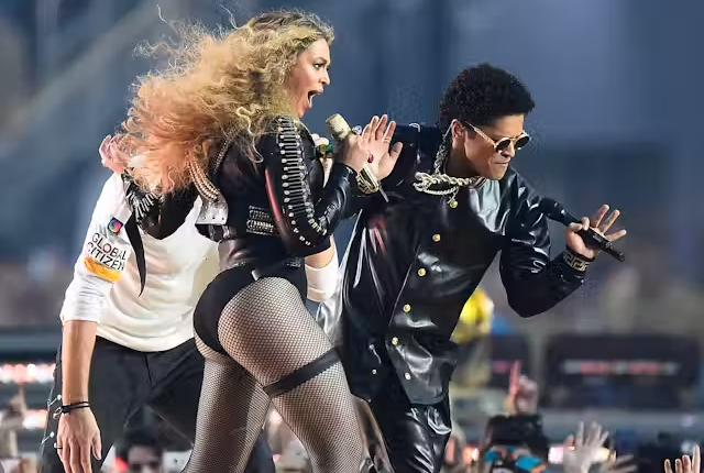 Beyonce performing on stage, showcasing her top songs and albums of all time as highlighted in the blog.